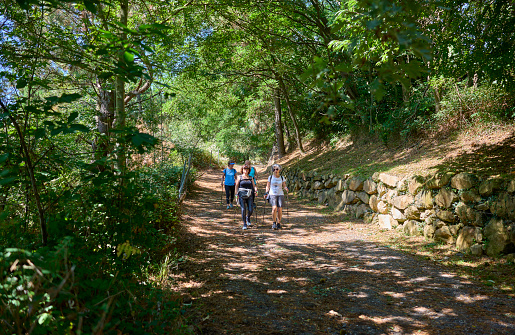 San Sebastian, Spain - August 20, 2022. Group of senior women friends hiking along trail in the Monte Ulia Mount. San Sebastian, Gipuzkoa, Basque country, Spain.