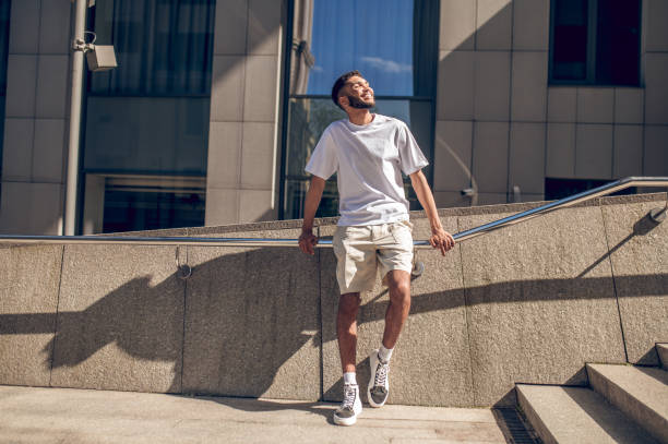 istock Young guy in light clothes outside in the business area 1419098734