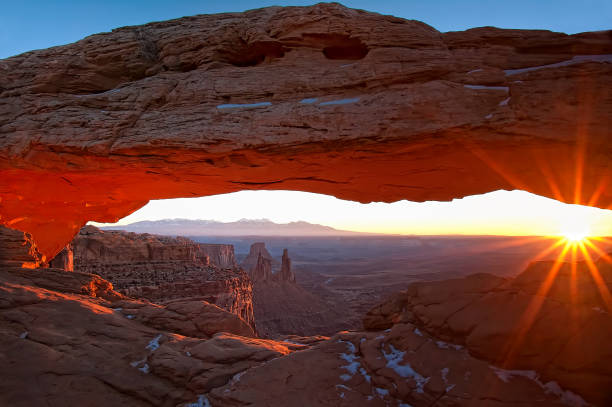 sun rising through mesa arch - travel famous place balanced rock beauty in nature imagens e fotografias de stock