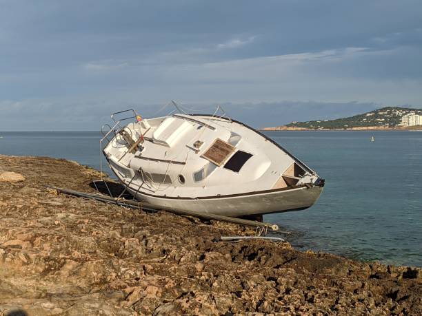 istock shipwreck on a beach after a storm. Insurance concept 1419104639