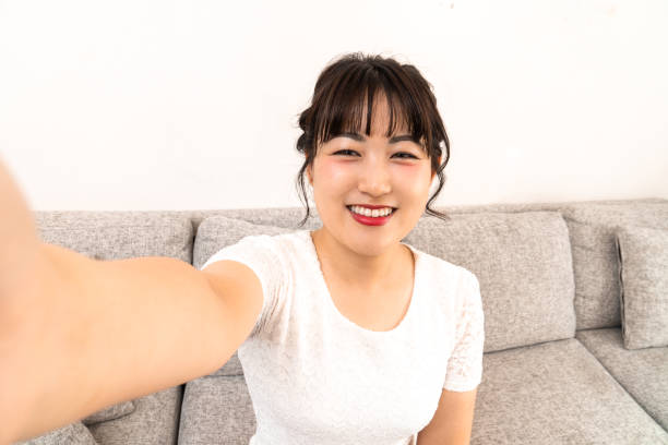 istock Young woman taking a selfie at home 1419108447