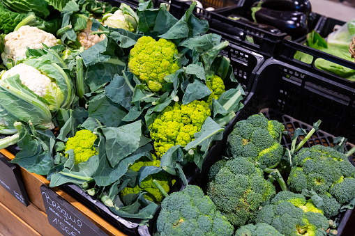 Fresh vegetables (broccoli, cauliflower and chard) in containers in supermarket