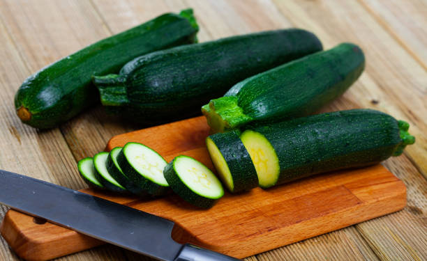 istock Image of cut raw green zucchini on wooden surface 1419112328