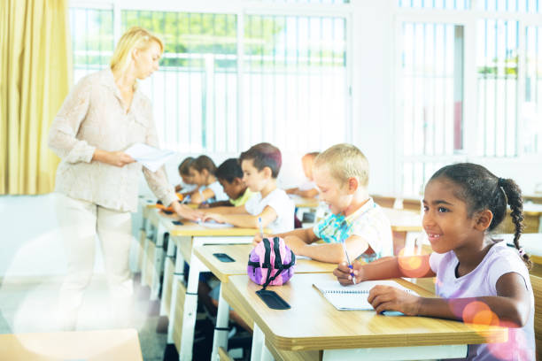istock Group of focused kids working at class 1419112558