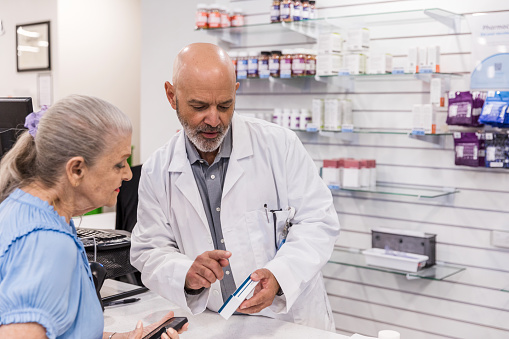 Female pharmacists are holding prescriptions from customers in pharmacies.