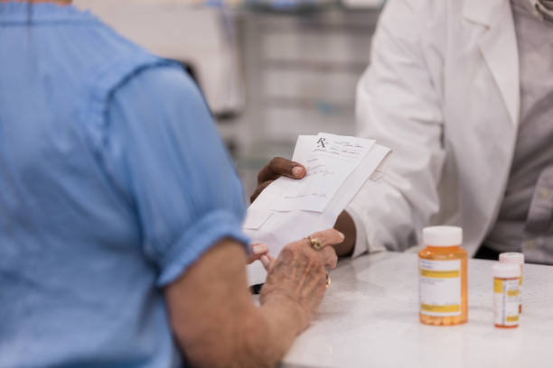 istock Unrecognizable male pharmacy tech hands female customer prescriptions 1419113471