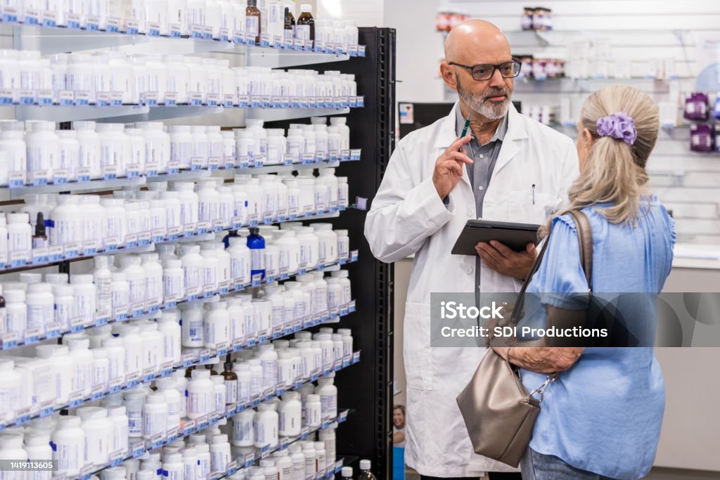 Pharmacy Employee Talks With The Female Patient Stock Photo Download Pharmacy Employee Talks With The Female Patient Stock Photo Download