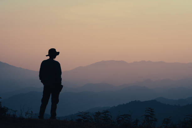istock Silhouette Man Standing On Mountain Against Sky 1419113613