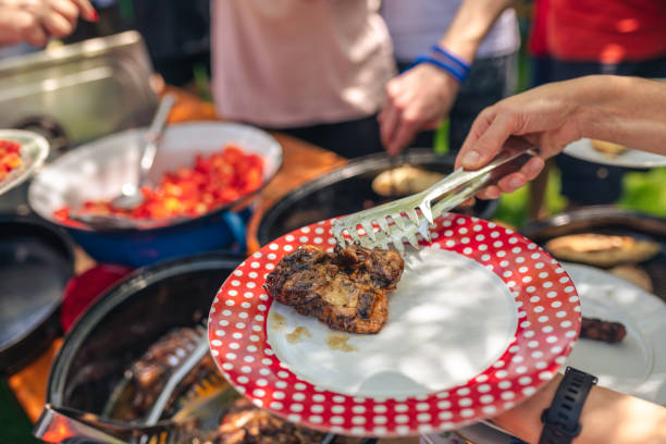 istock Serving food at neighborhood BBQ 1419116697