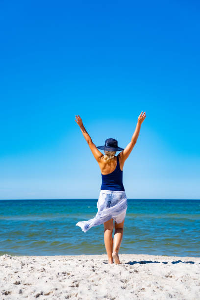 istock Beautiful woman walking on beach 1419117897