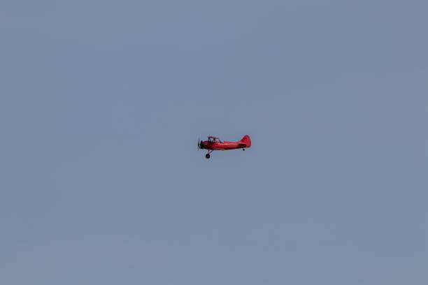 istock Vintage biplane flying in the cloudless sky 1419118761
