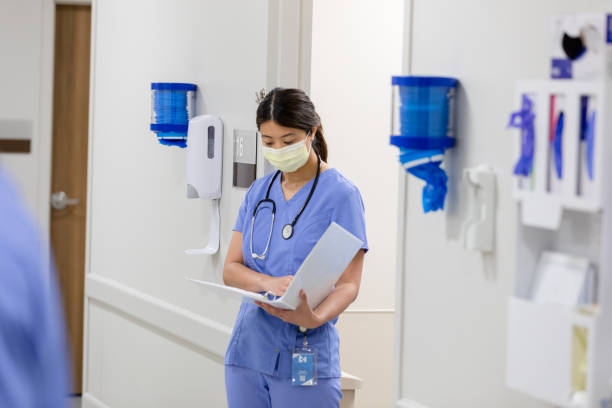 istock Female doctor reads over medical chart 1419121232