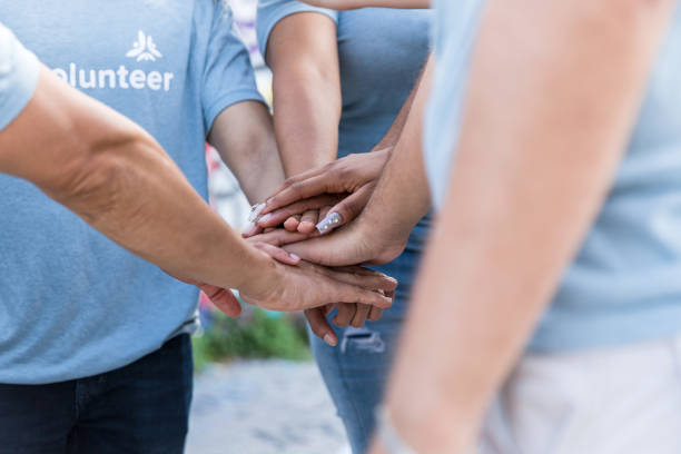 istock Close-up unrecognizable people putting hands together in unity 1419122262