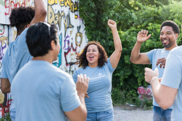 istock Diverse community members cheer before park clean-up 1419122271