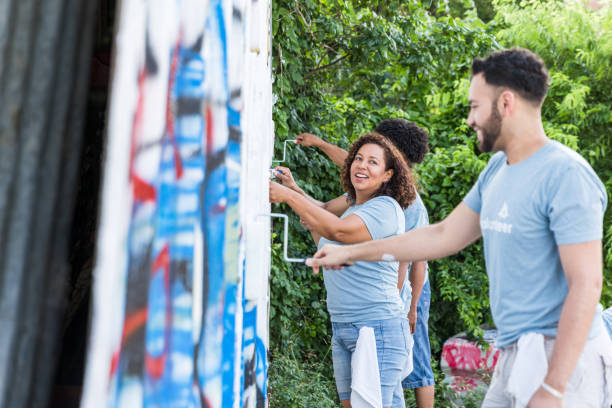 istock Volunteers chat while painting over graffiti 1419122291