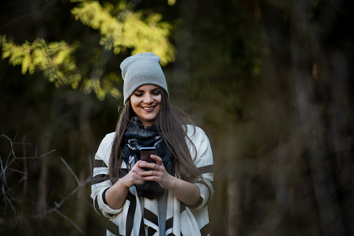 Woman taking selfie  in nature forest