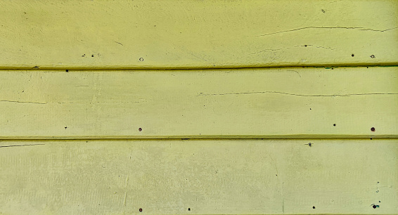Decorated wood wall with yellow color finished paint.