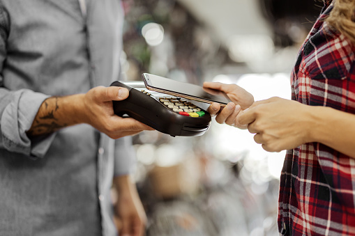 Customer paying through mobile phone using contactless technology