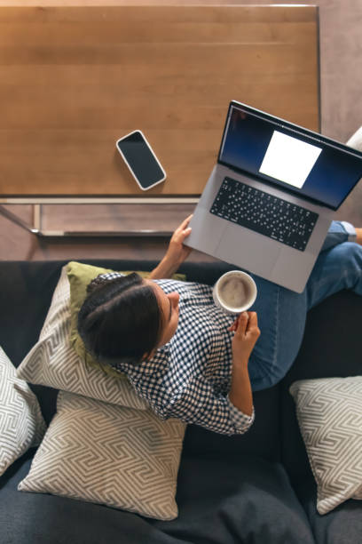 istock A young woman working on a laptop at home. 1419136319