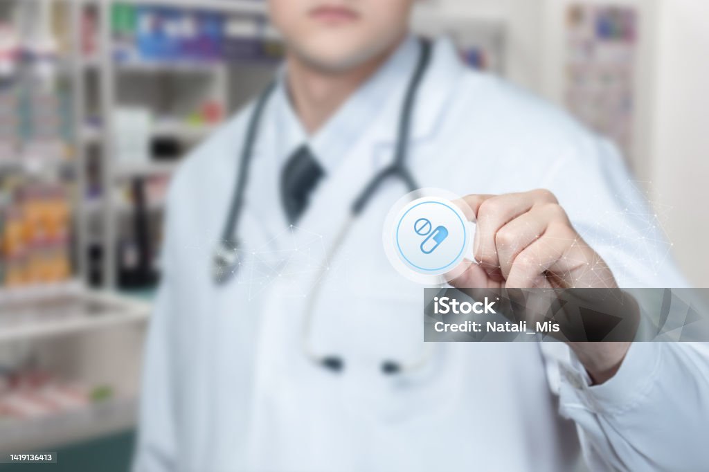 Pharmacist showing pills icon . Pharmacist showing pills icon on pharmacy blur background. Pill Stock Photo