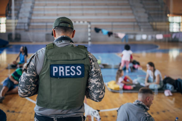 istock Army press with civilians after natural disaster 1419136510