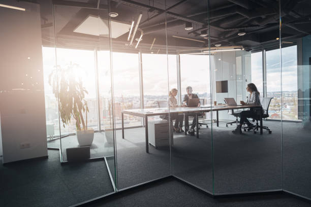 istock Creative business people working on project in modern office with panoramic view 1419137856