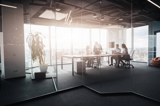 istock Team of businessmen communicating together in modern office with panoramic windows 1419137904