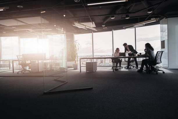 istock Creative business people working on project in modern office with panoramic view 1419137907