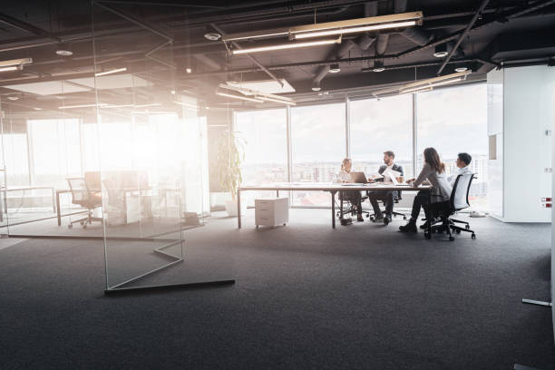 istock Creative business people working on project in modern office with panoramic view 1419137945