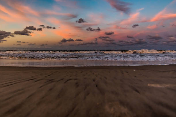 The Atlantic Ocean crashes on the beach of the Cape Hatteras National Seashore at dusk.