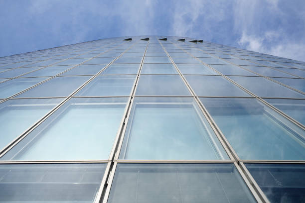 istock Facade of modern skyscraper with reflection of cloudy sky, low angle shot, free copy space 1419139764