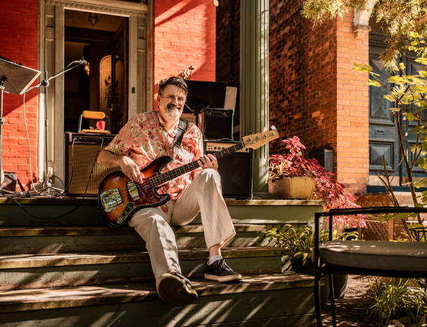 istock Middle age man playing bass guitar outdoors 1419139921