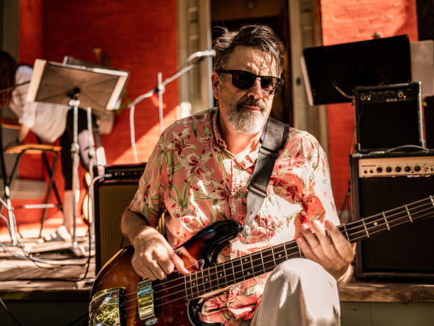 istock Middle age man playing bass guitar outdoors 1419140010