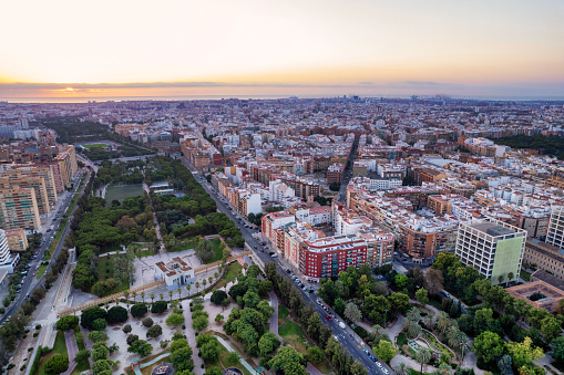 Aerial drone view of sunrise over Turia Gardens, a riverbed turned into a park, in Valencia, Spain