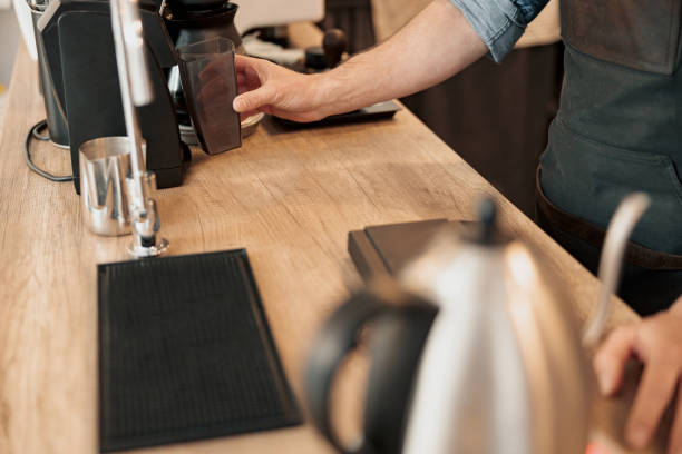 istock Barista installs a container with coffee beans in the coffee machine 1419141354