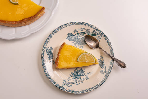 Part of lemon pie in an old plate on a white background