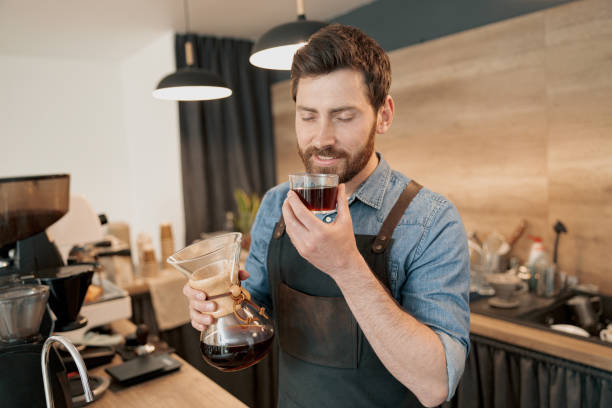 istock Handsome barista with stylish beard smelling filter coffee in cafeteria 1419142819