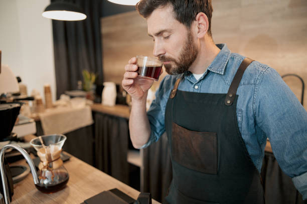 istock Handsome barista with stylish beard smelling filter coffee in cafeteria 1419142980