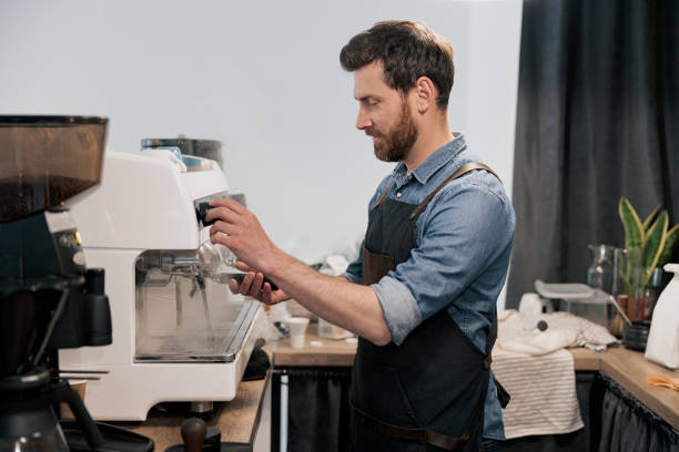 istock Barista washes a coffee machine and holds a coffee tank 1419143852