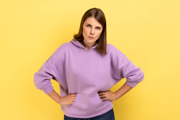 istock Serious woman looking at camera with strict negative expression, aggression, keeping hands on hips. 1419144193