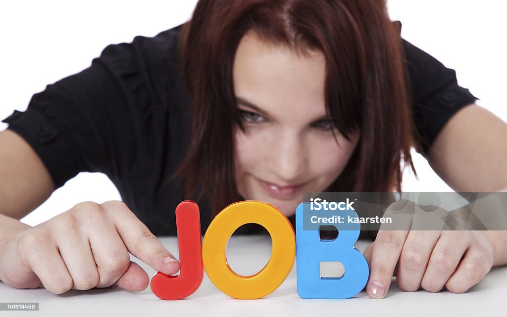 Teenage girl builds the term job Teenage girl building the term job out of colorful letters. Selective focus on hands and term in foreground. All on white background. Part-Time Job Stock Photo