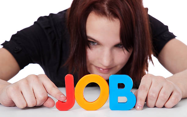 Teenage girl builds the term job Teenage girl building the term job out of colorful letters. Selective focus on hands and term in foreground. All on white background. career girl stock pictures, royalty-free photos & images
