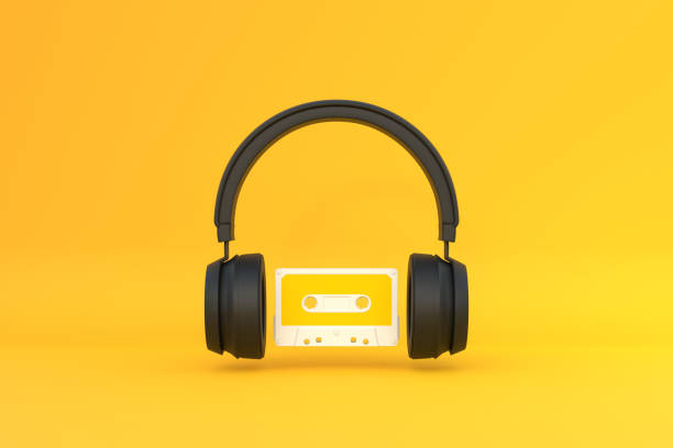 istock Wireless headphones with audio cassette on a yellow background 1419145938