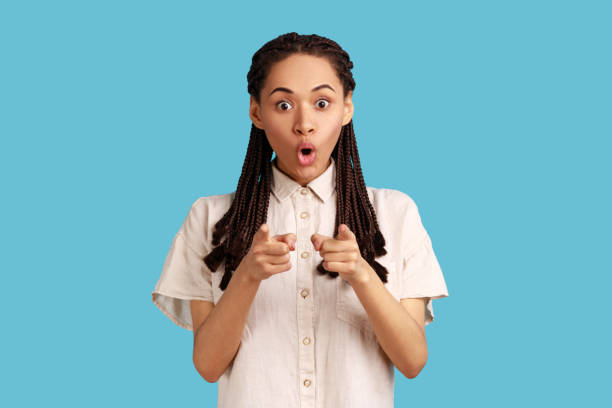 istock Surprised woman pointing directly at you, choosing something, has shocked expression. 1419146100