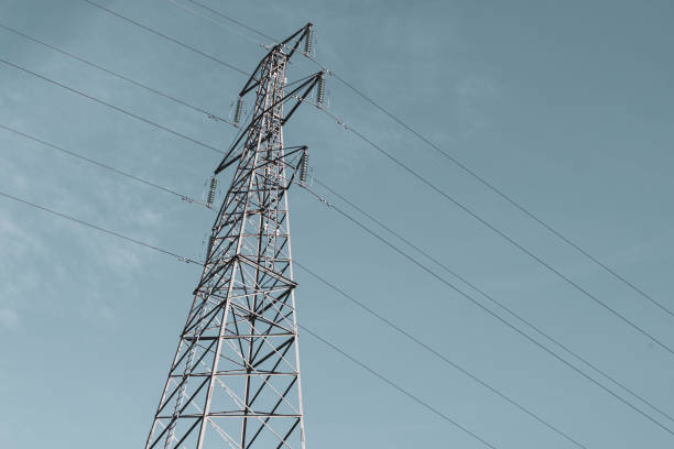 Electricity pylon against a blue sky stock photo