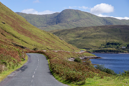Beautiful view of R335 Road and Killary Harbour on the side of Ben Gorm mountain on a sunny day, County Mayo, Ireland