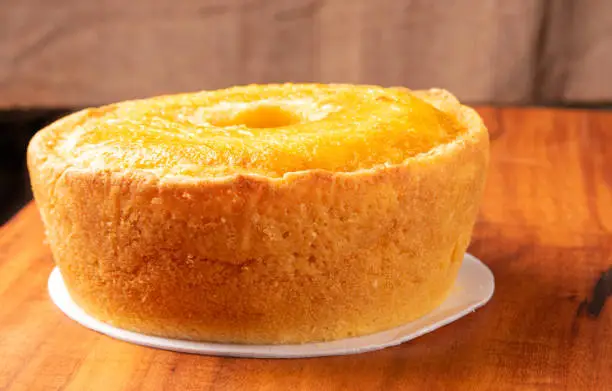 Photo of Corn cake on a styrofoam tray on a rustic wooden surface, selective focus.