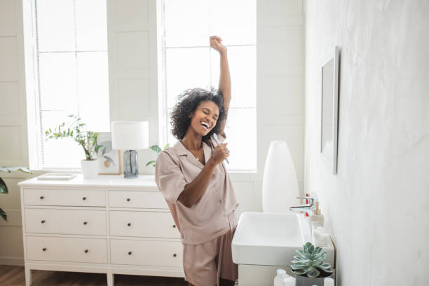 istock Smiling woman brushing healthy teeth in bathroom 1419150800