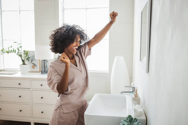 Fresh start of the morning Happy relaxed millennial African girl in pajama enjoying her morning. routine stock pictures, royalty-free photos & images