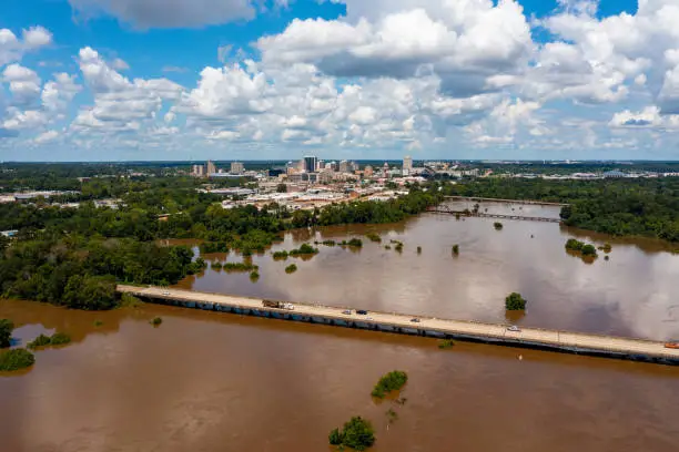 Photo of Jackson, MS Skyline with flooding Pearl River in the foreground in August 2022